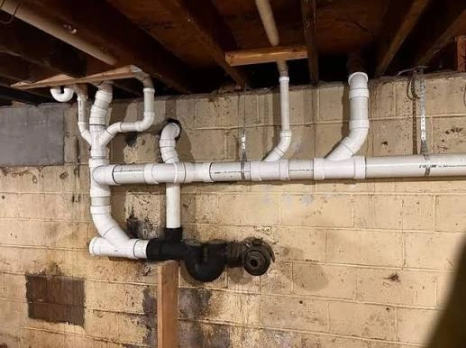 Organized basement plumbing pipes and water lines maintained by a reliable plumber near you in Highland Park